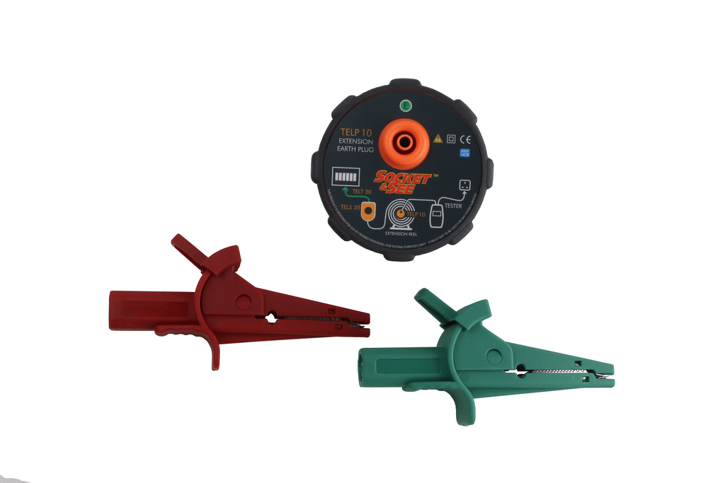 Two alligator clips, one red and one green, with a black circular device featuring orange and blue elements on a white background.